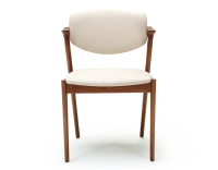 Scandinavian chair cherry wood stain with off-white fabric seat.