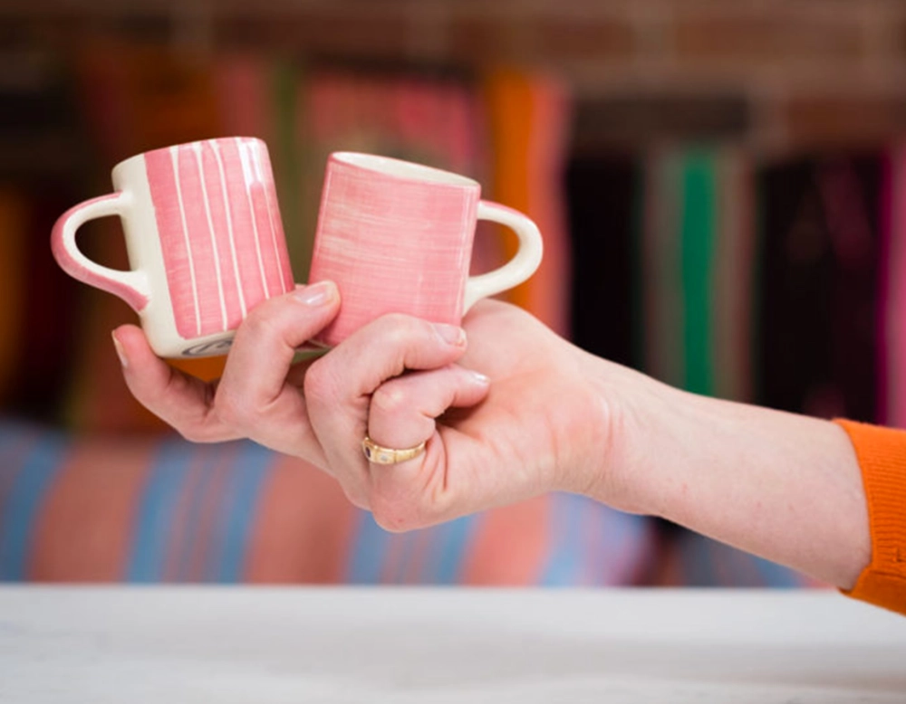 Striped pink ceramic coffee cup