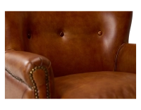 Fauteuil club cuir marron clair accoudoirs cloutés