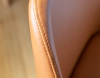 Designer chair natural stained wood and caramel leather