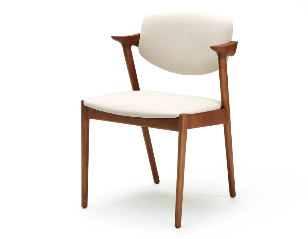 Scandinavian chair cherry wood stain with off-white fabric seat.