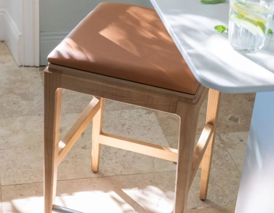 H60 cm designer bar stool natural tint wood, caramel leather seat