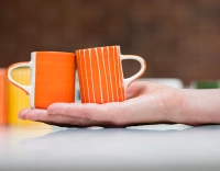 Orange ribbed ceramic coffee cup