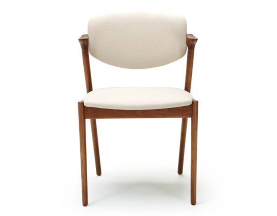 Scandinavian chair cherry wood stain with off-white fabric seat.