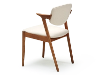 Scandinavian chair cherry wood stain with off-white fabric seat.