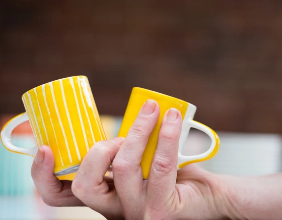 Plain yellow ceramic coffee mug