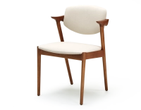 Scandinavian chair cherry wood stain with off-white fabric seat.