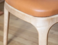 Designer chair natural stained wood and caramel leather