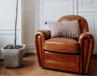 Fauteuil club cuir marron clair accoudoirs cloutés